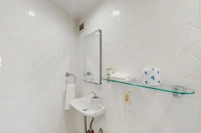 a white bathroom with a sink and a mirror at Miami Lux Haven in Miami Beach