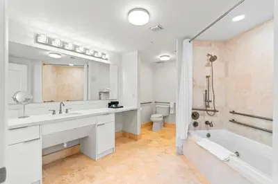 a bathroom with a sink and a tub and a toilet at Luxury Condo at Trésor Miami Beach in Miami Beach