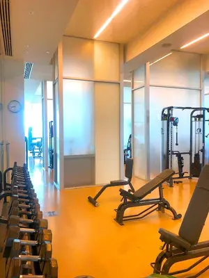 a gym with several treadmills and machines in a room at Luxury Condo at Trésor Miami Beach in Miami Beach
