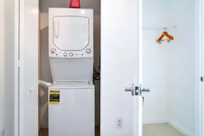 a microwave oven sitting on top of a refrigerator at Miami Midblock Condo - City Views, Pool & Balcony! in Miami