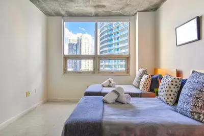 a bedroom with two beds with stuffed animals on them at Miami Midblock Condo - City Views, Pool & Balcony! in Miami