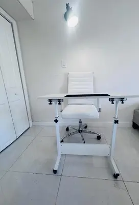 a white table with a white chair sitting in a room at Tempurpedic Queen - Laundry, Parking & EV Charger in Hollywood
