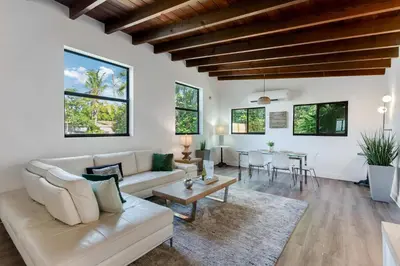 a living room with a couch and a table at Hidden Bungalow- Peaceful retreat BBQ and hot tub in Miami