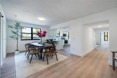 a dining room and kitchen with a table and chairs at Oceanview Crespi Villa in Miami Beach