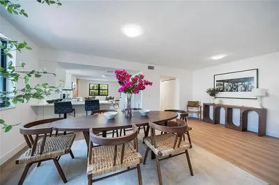 a dining room and living room with a table and chairs at Oceanview Crespi Villa in Miami Beach