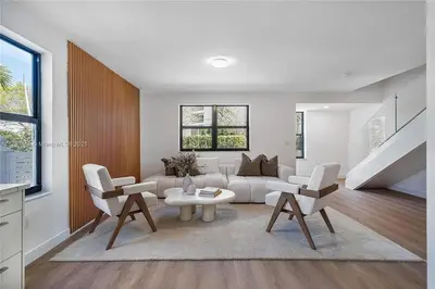 a living room with a couch and a table and chairs at Oceanview Crespi Villa in Miami Beach