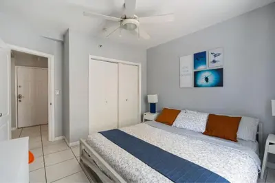 a bedroom with a bed and a ceiling fan at South Beach Luxury, 2 Bedroom, Across from Beach in Miami Beach
