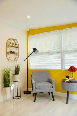 a living room with a chair and a lamp at Vibrant 4bd 2ba Miami Home w POOL in Miami