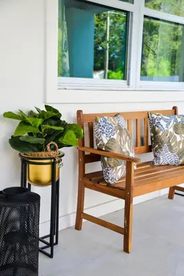 a wooden bench sitting in front of a window at Vibrant 4bd 2ba Miami Home w POOL in Miami