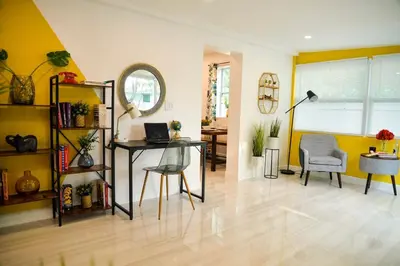a living room with a table and a chair at Vibrant 4bd 2ba Miami Home w POOL in Miami