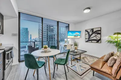 a living room with a table and chairs at Modern Studio City Views in Miami