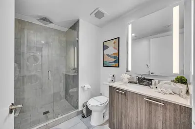 a bathroom with a shower and a toilet and a sink at Modern Studio City Views in Miami
