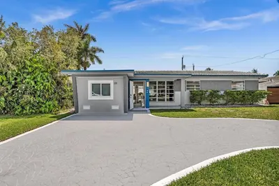 a house with a driveway in front of it at 4BR Home Heated Pool And BBQ short drive Beach! in Hollywood