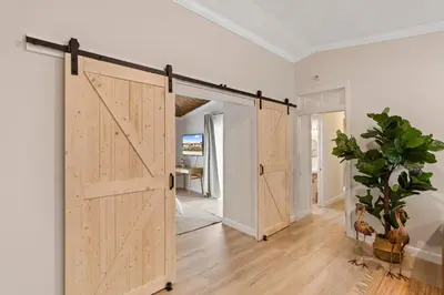 a sliding barn door in a living room at Boho Style 5 BR 2,5 BT Heated Pool Fit 14 in Miami
