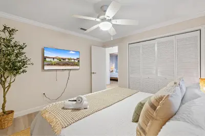 a bedroom with a bed and a ceiling fan at Boho Style 5 BR 2,5 BT Heated Pool Fit 14 in Miami