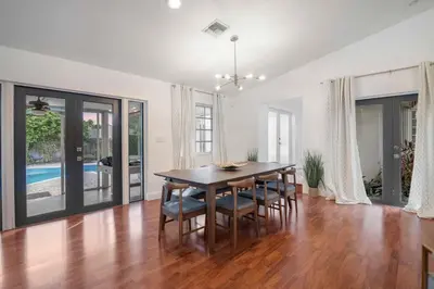 a dining room with a table and chairs at Firepit, Beach, Basketball, LuxuryVilla in Palmetto Bay