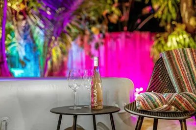 a bottle of wine sitting on a table next to two chairs at Firepit, Beach, Basketball, LuxuryVilla in Palmetto Bay
