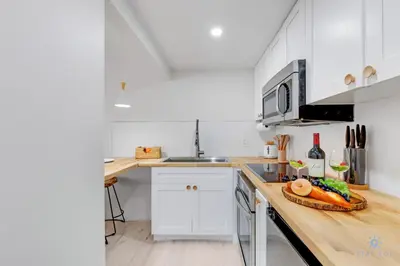 a kitchen with a counter with a plate of food on it at Spacious Apt 2 Blocks to Beach and Collins Park in Miami Beach