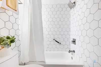 a bathroom with a shower with a white shower curtain at Spacious Apt 2 Blocks to Beach and Collins Park in Miami Beach
