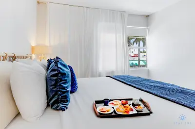 a tray of food sitting on top of a bed at Spacious Apt 2 Blocks to Beach and Collins Park in Miami Beach