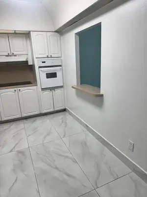a kitchen with white cabinets and a tile floor at Beatiful apartment 2nd Floor - SRT 3143 in Sunny Isles Beach