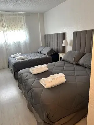 two beds in a hotel room with towels on them at Beatiful apartment 2nd Floor - SRT 3143 in Sunny Isles Beach