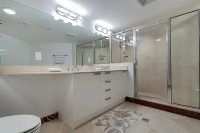 a white bathroom with a shower and a toilet at Pierfront Escape in Sunny Isles Beach