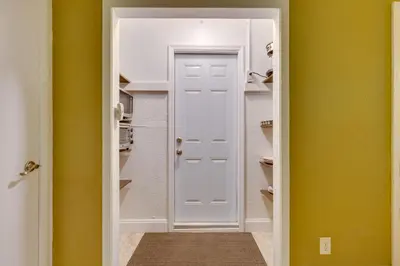 a closet with a white door and yellow walls at Fort Lauderdale Studio Near Beaches and Downtown in Fort Lauderdale