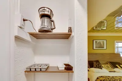 a room with a lamp on a shelf next to a bed at Fort Lauderdale Studio Near Beaches and Downtown in Fort Lauderdale