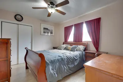 a bedroom with a bed and a ceiling fan at Lakefront Getaway with Dock Near Las Olas Beach in Fort Lauderdale