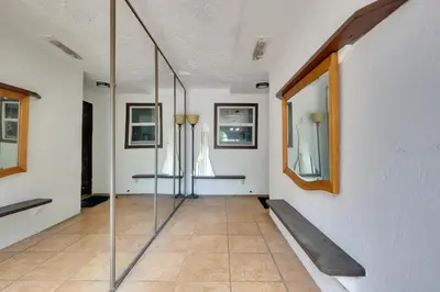 a hallway with glass doors and a tile floor at Lakefront Getaway with Dock Near Las Olas Beach in Fort Lauderdale