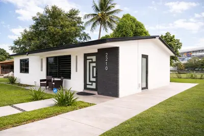 a small white building with a black door at Casa Hard Rock Stadium in Miami Gardens