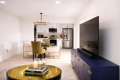 a living room with a large television and a table at Casa Hard Rock Stadium in Miami Gardens