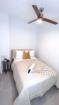 a bedroom with a bed with a ceiling fan at Comfortable 2BR Apartment with Pool and Gym, Steps from Jackson Memorial in Miami
