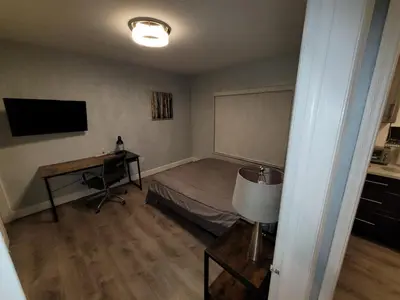 a bedroom with a bed and a desk and a television at A place that will make you want to come back again in Miami Beach