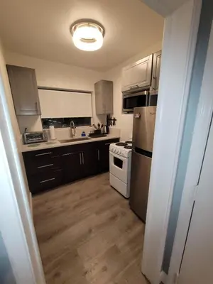 a kitchen with a refrigerator and a stove top oven at A place that will make you want to come back again in Miami Beach