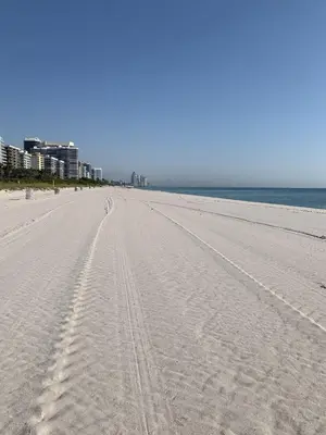 an empty beach with footprints in the sand at A place that will make you want to come back again in Miami Beach