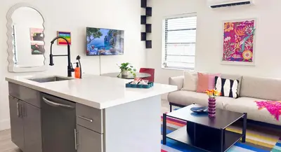 a kitchen and living room with a sink and a couch at The Chill Pill - Wilton Drive and Jacuzzi in Fort Lauderdale