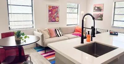 a kitchen and living room with a sink and a couch at The Chill Pill - Wilton Drive and Jacuzzi in Fort Lauderdale