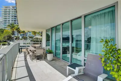 a balcony with a table and chairs on a building at Beachfront Bliss in Miami in Miami Beach