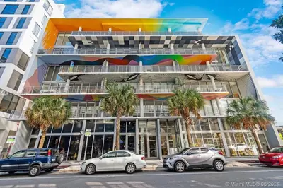 a building with cars parked in front of it at LoveShack Wynwood in Miami