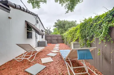 a patio with chairs and a table and a fence at 3 Mi to Beach Hollywood Studio with Yard! in Hollywood