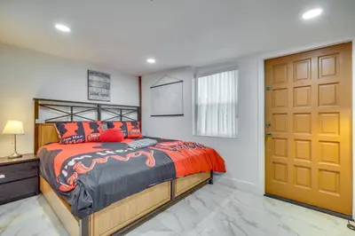 a bedroom with a bed and a wooden door at 3 Mi to Beach Hollywood Studio with Yard! in Hollywood