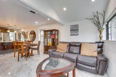 a living room with a leather couch and a table at 3 Mi to Beach Hollywood Treehouse with Deck and Yard! in Hollywood