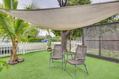 two chairs on a lawn under a canopy at 3 Mi to Beach Hollywood Treehouse with Deck and Yard! in Hollywood