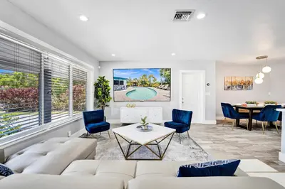 a living room with a couch and a table at NEW! Private Oasis with Heated Pool Minutes to Wilton Dr and the Beach in Fort Lauderdale