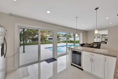 a kitchen with a view of a pool at Waterfront Oasis with Private Pool in Fort Lauderdale