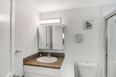 a bathroom with a sink and a toilet at Waterfront Oasis with Private Pool in Fort Lauderdale
