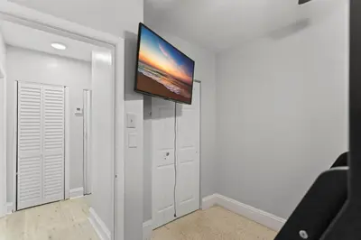a living room with a flat screen tv on a wall at Family Oasis Near Hard Rock Stadium & Beaches in Norland