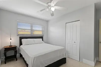 a bedroom with a bed and a ceiling fan at Family Oasis Near Hard Rock Stadium & Beaches in Norland